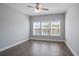 This cozy bedroom features hardwood floors and natural light from three windows with blinds at 4335 Hastings Dr, Cumming, GA 30041