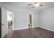 Bedroom featuring wood floors and neutral walls, with an open doorway to hallway and bathroom at 4335 Hastings Dr, Cumming, GA 30041