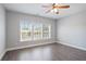 Bedroom featuring wood floors, neutral walls and large window for ample natural light at 4335 Hastings Dr, Cumming, GA 30041