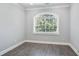 Bright bedroom featuring wood-look floors and a large window providing natural light, creating a tranquil retreat at 4335 Hastings Dr, Cumming, GA 30041