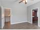 Bedroom featuring wood floors, neutral walls, and two open doorways at 4335 Hastings Dr, Cumming, GA 30041