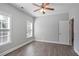 Bedroom featuring wood floors, neutral walls, window and open doorway to bathroom at 4335 Hastings Dr, Cumming, GA 30041