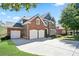 Angle view of beautiful brick home with manicured lawn and a long concrete driveway at 4335 Hastings Dr, Cumming, GA 30041