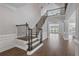 Elegant foyer with hardwood floors, fresh paint, and a staircase with wrought iron spindles at 4335 Hastings Dr, Cumming, GA 30041