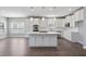 Modern kitchen boasts white cabinetry, stainless steel appliances, and a central island at 4335 Hastings Dr, Cumming, GA 30041