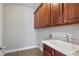 Spacious laundry room boasts ample cabinet space and a deep utility sink at 4335 Hastings Dr, Cumming, GA 30041