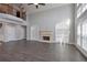 Bright living room with hardwood floors, a fireplace, built-in shelves and large windows at 4335 Hastings Dr, Cumming, GA 30041