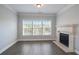 Cozy living area featuring a stone fireplace, recessed lights, and a large window providing a relaxing ambiance at 4335 Hastings Dr, Cumming, GA 30041