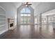 Spacious living room with hardwood floors, large window, fireplace, and high ceiling at 4335 Hastings Dr, Cumming, GA 30041