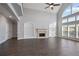 Bright living room with hardwood floors, a fireplace, built-in shelves, and expansive windows at 4335 Hastings Dr, Cumming, GA 30041