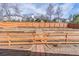 A large backyard with tiered wooden retaining walls and a tall wooden fence surrounding the property at 965 Mulberry Bay Dr, Dacula, GA 30019