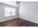 Bright bedroom with hardwood floors, ceiling fan, and large window providing natural light at 965 Mulberry Bay Dr, Dacula, GA 30019