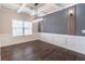 Elegant dining room with coffered ceiling, modern light fixture, and decorative wall paneling at 965 Mulberry Bay Dr, Dacula, GA 30019