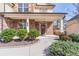 Inviting front porch with well-manicured shrubs, brick detailing, and a welcoming entrance creates a great first impression at 965 Mulberry Bay Dr, Dacula, GA 30019