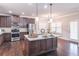 Well-equipped kitchen with granite island, stainless steel appliances, and dark wood cabinets at 965 Mulberry Bay Dr, Dacula, GA 30019