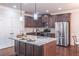 Gourmet kitchen with granite island, stainless steel appliances, and dark wood cabinetry at 965 Mulberry Bay Dr, Dacula, GA 30019