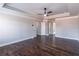 Large main bedroom with dark wood flooring, tray ceiling, and walk-in closet at 965 Mulberry Bay Dr, Dacula, GA 30019