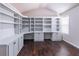 Office showcasing custom built-in shelving and cabinets with dark hardwood floors and natural light at 965 Mulberry Bay Dr, Dacula, GA 30019