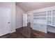 Office with custom white shelving and dark hardwood floors, with views to the hallway at 965 Mulberry Bay Dr, Dacula, GA 30019