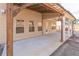 Covered patio showcasing a concrete floor, ceiling fan, wood and steel beam construction, and outdoor lighting at 965 Mulberry Bay Dr, Dacula, GA 30019