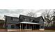 Newly built home with a combination of lap siding, metal roof accents, and expansive front porch at 157 Palisade Dr, Rydal, GA 30171