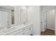 Bathroom with double sink vanity, white cabinetry, modern fixtures, and an adjacent walk-in shower at 2777 Aralynn Way, College Park, GA 30337