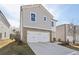 Lovely two-story home featuring a stone-accented garage and a spacious driveway at 2777 Aralynn Way, College Park, GA 30337