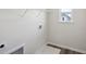 Laundry room featuring new vinyl flooring and a laundry sink and large window at 2777 Aralynn Way, College Park, GA 30337