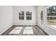 Bright room with hardwood floors, featuring two windows and a glass patio door at 2777 Aralynn Way, College Park, GA 30337