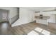 Bright open living area with hardwood floors, stairs and a view of the kitchen at 2777 Aralynn Way, College Park, GA 30337
