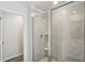 Modern shower with light tile and glass door, complete with fixtures and a built-in shelf for added convenience at 2777 Aralynn Way, College Park, GA 30337