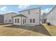 View of the backyard with a lawn, patio, and the rear elevation of the home at 2778 Aralynn Way, College Park, GA 30337
