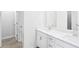 Bathroom features a double sink vanity with white cabinets and modern fixtures plus wood look floor at 2778 Aralynn Way, College Park, GA 30337