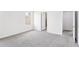An airy bedroom showcases gray carpet, white walls, two windows, and doorway to the ensuite bath at 2778 Aralynn Way, College Park, GA 30337