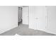 Bedroom with neutral walls, neutral carpet, and two white doors at 2778 Aralynn Way, College Park, GA 30337