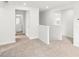 Upstairs hallway with neutral carpet, white walls, and a view of the bathroom at 2778 Aralynn Way, College Park, GA 30337