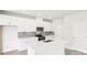 Modern kitchen featuring white cabinets, quartz countertops, stainless steel appliances, and a large center island at 2778 Aralynn Way, College Park, GA 30337