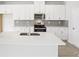 Modern kitchen featuring white cabinets, quartz countertops, stainless steel appliances, and a center island at 2778 Aralynn Way, College Park, GA 30337