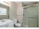 Bathroom featuring a shower with glass doors, vanity with sink, and mirror at 467 Pineburr Ln, Stone Mountain, GA 30087