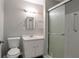 Classic bathroom with a vanity, toilet, mirror and shower with glass doors at 467 Pineburr Ln, Stone Mountain, GA 30087