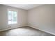 Empty bedroom with natural light features fresh paint, carpet and a large window with outdoor view at 467 Pineburr Ln, Stone Mountain, GA 30087