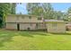 Back exterior view of the home with a brick foundation, deck, and expansive backyard at 467 Pineburr Ln, Stone Mountain, GA 30087