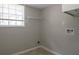 The laundry room has a window for natural light, and an upper rack for storage at 467 Pineburr Ln, Stone Mountain, GA 30087