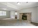 Cozy living room features a charming brick fireplace, new carpet, and fresh paint throughout at 467 Pineburr Ln, Stone Mountain, GA 30087