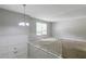 Upstairs living room filled with sunlight boasts fresh paint, large windows, and new carpet at 467 Pineburr Ln, Stone Mountain, GA 30087