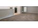 Open-concept kitchen and living area featuring new carpet and stainless steel appliances at 467 Pineburr Ln, Stone Mountain, GA 30087