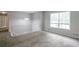 Spacious carpeted living room with stairs, large window and contemporary lighting fixture at 467 Pineburr Ln, Stone Mountain, GA 30087