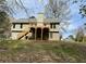 Backyard view of the house featuring a spacious wooden deck with stairs to the yard at 535 Clearwater Pl, Lawrenceville, GA 30044