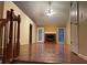 Open living room featuring hardwood floors, a brick fireplace, and a staircase to the upper level at 535 Clearwater Pl, Lawrenceville, GA 30044