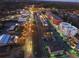 Aerial view of downtown at night showcasing buildings, streets, and lights at 642 Stickley Oak Way, Woodstock, GA 30189